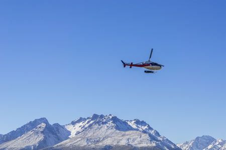 AORAKI MOUNT COOK, NEW ZEALAND 16TH APRIL 2014; Unidentified helicopter flying over the amazing West Coast, South Island, New Zealand.のeditorial素材