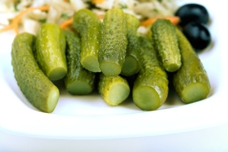 Pickled cucumbers and other vegetables on the plateの写真素材