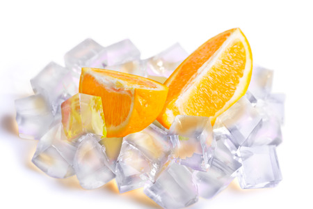 Ice cubes and orange slices isolated on white backgroundの写真素材