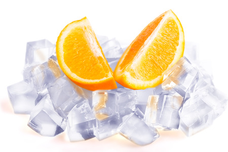 Ice cubes and orange slices isolated on white backgroundの写真素材