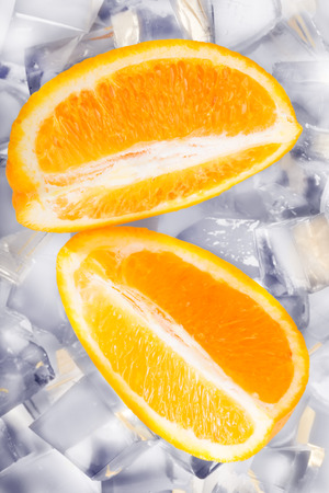 Ice cubes and orange slices isolated on white backgroundの写真素材