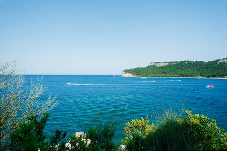Beautiful seascape with sea, clouds, mountains and yachtの写真素材