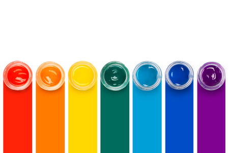 Paint in the glass jars on the colourful lines backgroundの写真素材