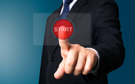 Business person working with modern virtual technology (screen start button)の写真素材
