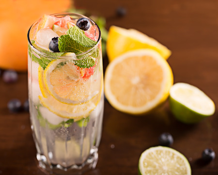 Fresh cocktail with mint, grapefruit and berries on the tableの写真素材