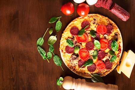 Tasty italian pizza with sausages and mushroomsの写真素材
