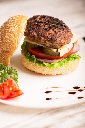 Homemade hamburger with vegetables on the plateの写真素材