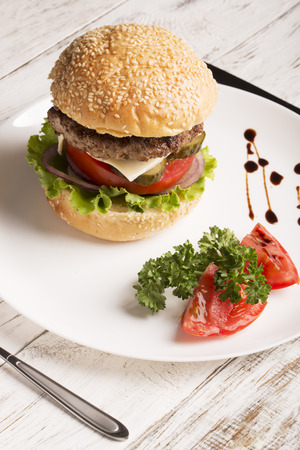 Homemade hamburger with vegetables and wineの写真素材