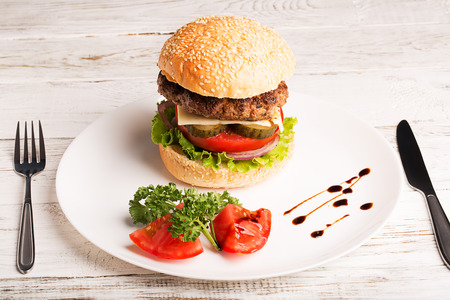 Homemade hamburger with vegetables and wineの写真素材