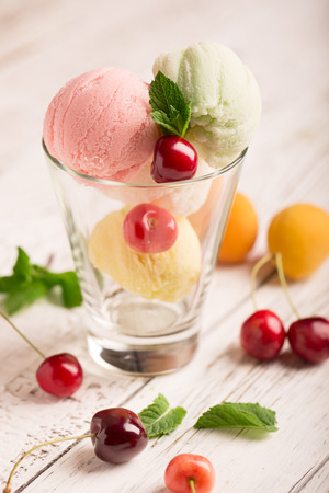 Tasty ice cream with cherry and apricotの写真素材