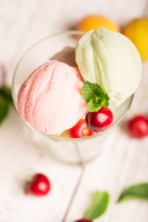 Tasty ice cream with cherry and apricotの写真素材