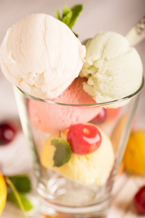 Tasty ice cream with cherry and mintの写真素材