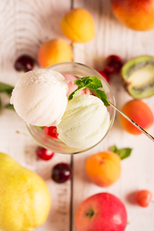 Tasty ice cream with cherry and fruitsの写真素材