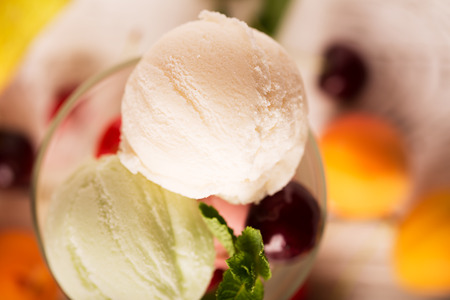 Tasty ice cream with cherry and fruitsの写真素材