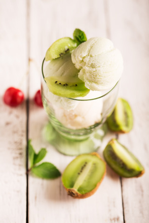 Tasty ice cream with cherry and mintの写真素材