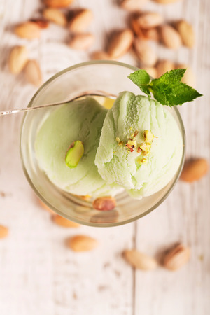 Tasty ice cream with pistachios and mintの写真素材