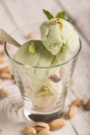 Tasty ice cream with pistachios and mintの写真素材