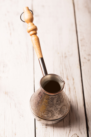 Coffee maker on a white wooden tableの写真素材
