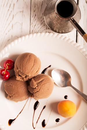 Chocolate ice cream with cherry and apricotの写真素材