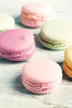 Colorful macaroons on a blue wooden tableの写真素材