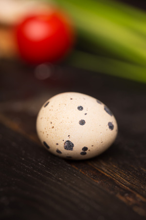Quail egg on a dark wooden table (with copy space)の写真素材