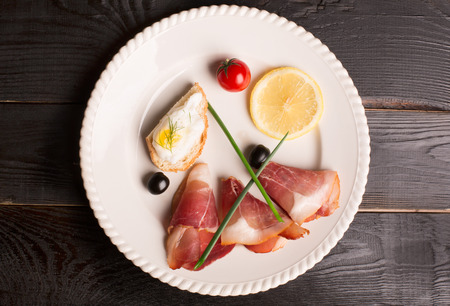 Tasty tapas and jamon on a white plateの写真素材