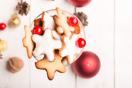 Glass of Christmas cookies on the white table