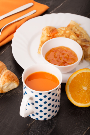 Carrot juice and breakfast from omelette and croissantの写真素材