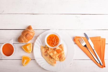 Omelette with pumpkin, carrot juice and croissant on the tableの写真素材