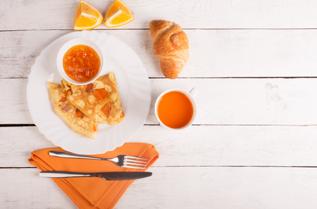 Omelette with pumpkin, carrot juice and croissant on the tableの写真素材