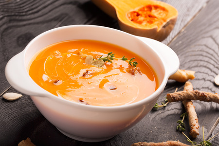 Delicious pumpkin soup puree with cream and croutonsの写真素材