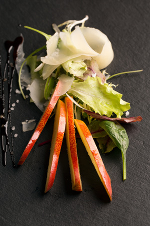 Fresh vegetable salad with caramelized pear and parmesanの写真素材