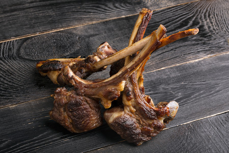 Grilled lamb ribs with parsley on the wooden table