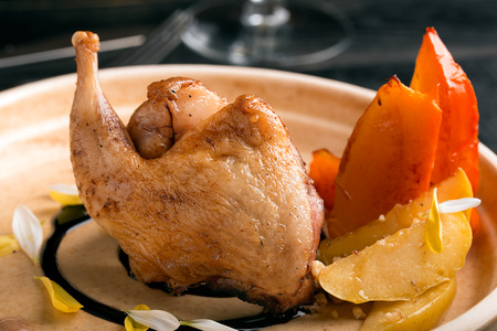 Quail thigh with caramelized apples and persimmonsの写真素材