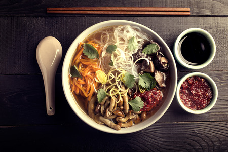 Traditional chinese soup with noodles, mushrooms and vegetablesの写真素材