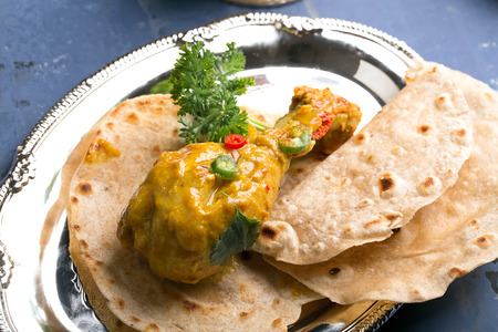 Delicious chicken thighs with curry sauce and chiliの写真素材