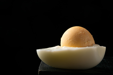 Soft boiled egg on a stand. Dark wooden backgroundの写真素材