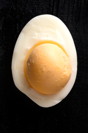 Soft boiled egg on a stand. Dark wooden backgroundの写真素材