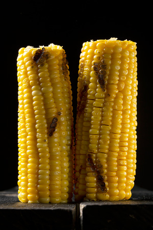 Natiral grilled corn on the dark wooden tableの写真素材
