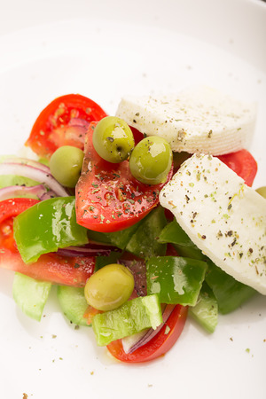 Greek salad with fresh vegetables, feta cheese and green olivesの写真素材