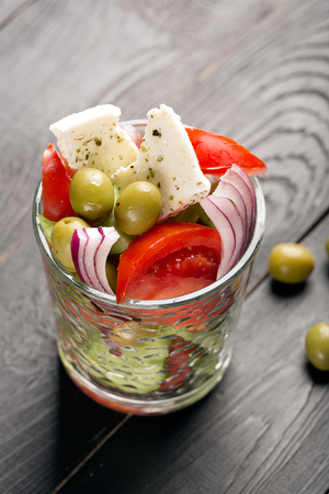 Greek salad with fresh vegetables, feta cheese and green olivesの写真素材