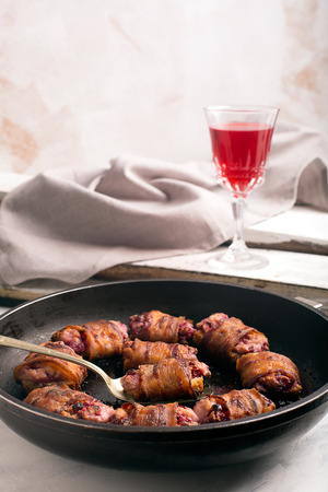 Rich snack of bacon and bread stuffed with cheese and cranberriesの写真素材