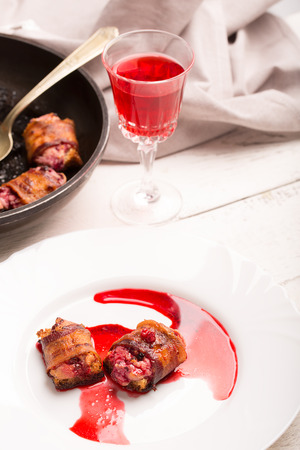 Rich snack of bacon and bread stuffed with cheese and cranberriesの写真素材
