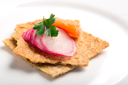 Snack with salmon, parsley and radish