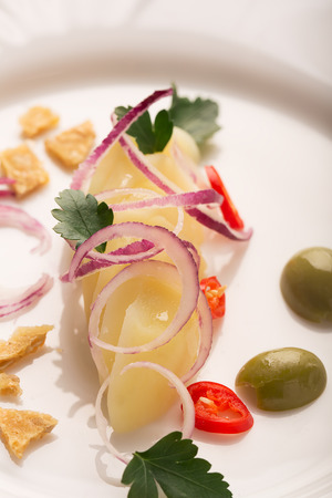 Potato salad with red onion, olives and parsleyの写真素材