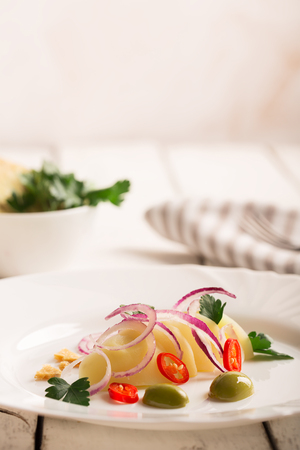 Potato salad with red onion, olives and parsleyの写真素材