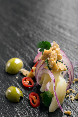 Potato salad with red onion, olives and parsleyの写真素材