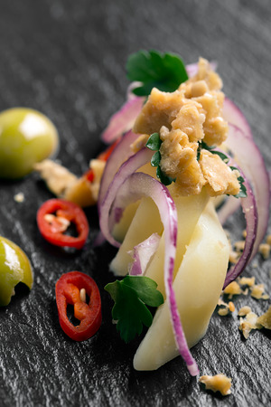 Potato salad with red onion, olives and parsleyの写真素材