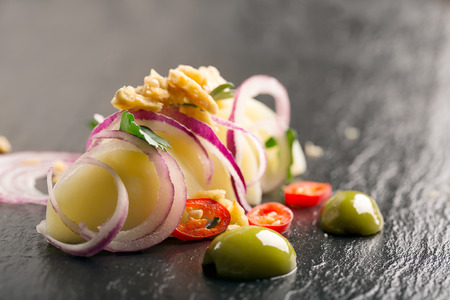 Potato salad with red onion, olives and parsleyの写真素材