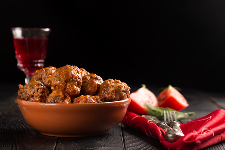 Meat balls in tomato sauce on a black backgroundの写真素材